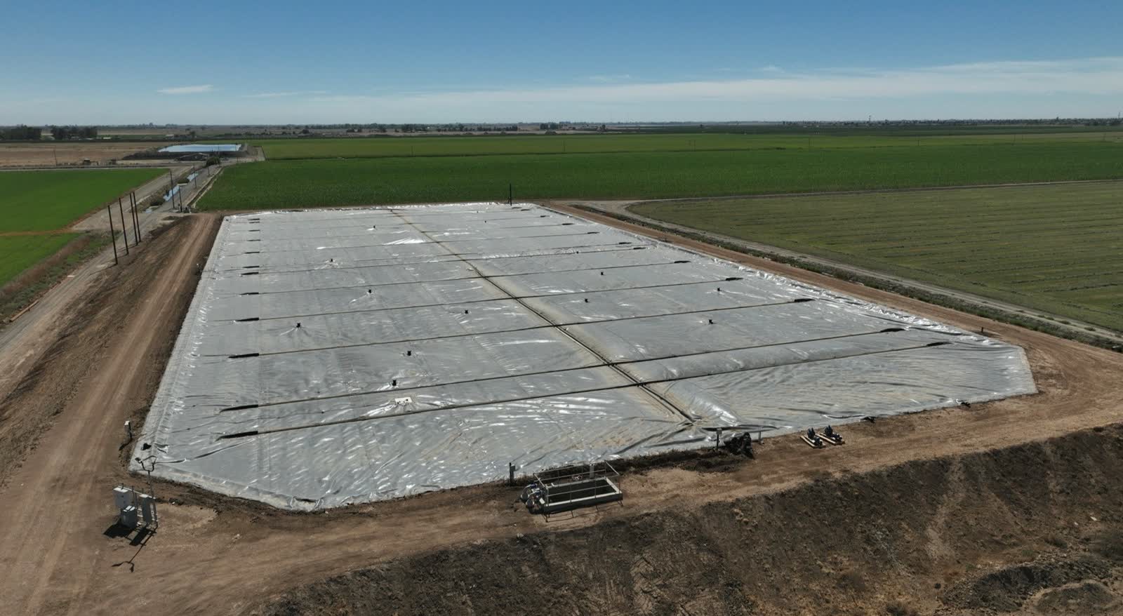 A covered lagoon digester at work between the fields